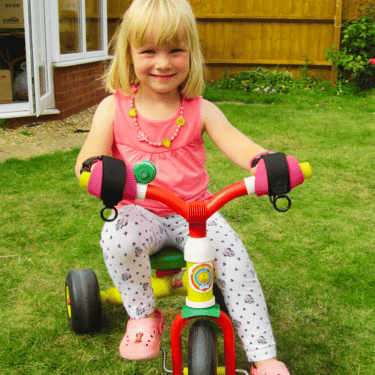 little-girl-wearing-ornamin-kids-mini-small-gripping-aids-while-biking